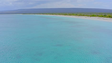 Aerial-flyover-crystal-clear-and-tropical-Caribbean-Sea-and-exotic-landscape-in-background