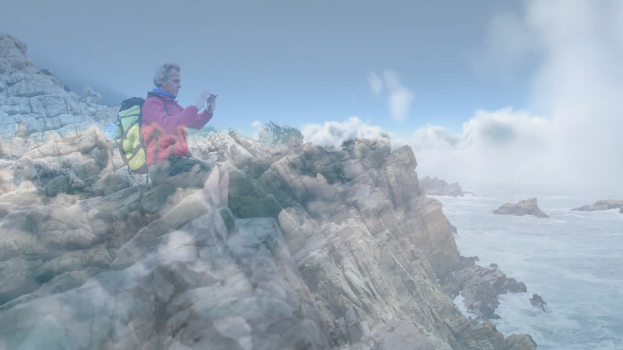 man hiker pointing toward animated route lines on rugged coastal cliff view, displaying travel data