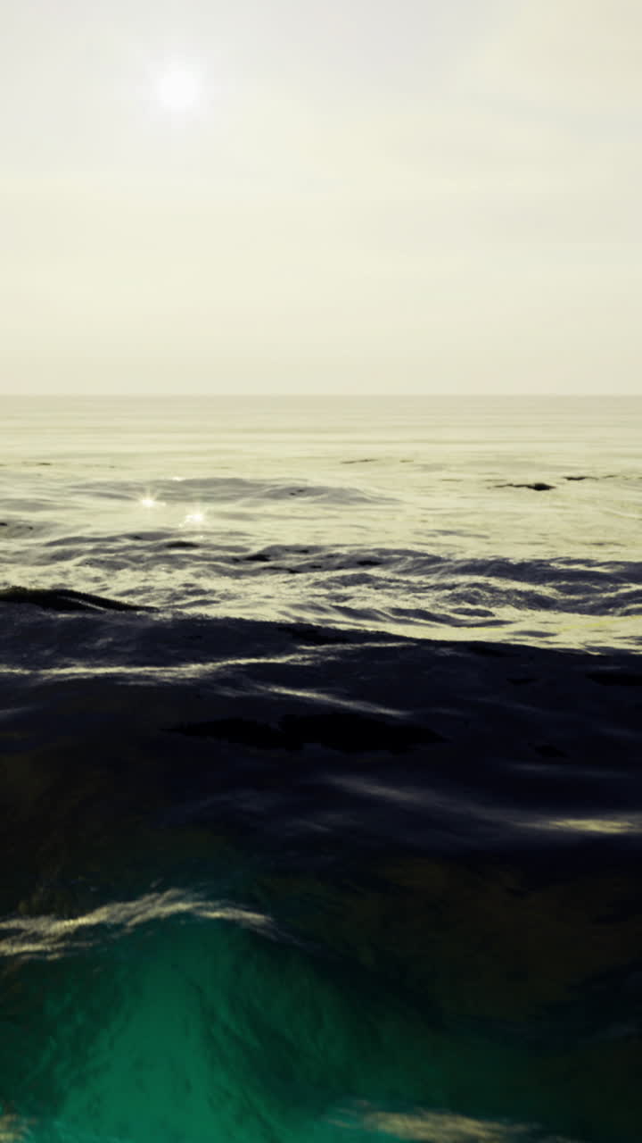 Serene ocean view with gentle waves and warm sunlight at dusk