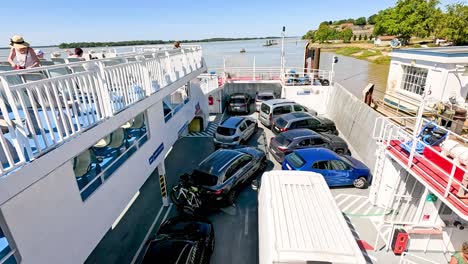 vehicles and passengers on a ferry crossing