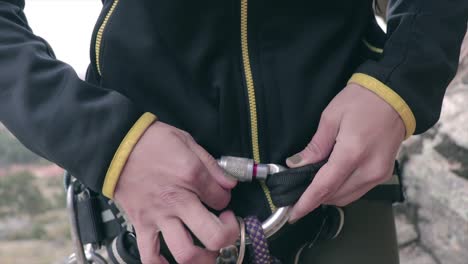 rock climber closing her carabiner before climbing