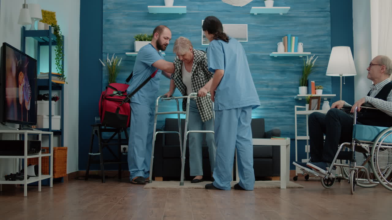 Nurses helping disabled pensioner to use walk frame