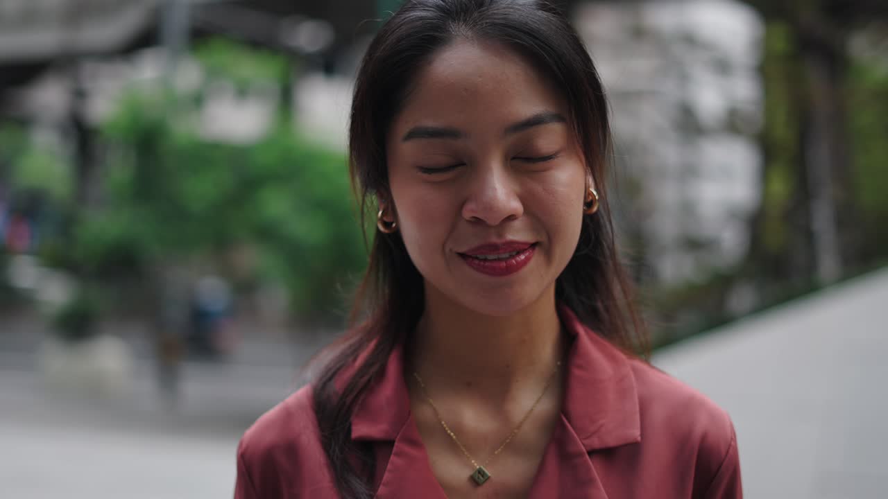 Smiling Asian woman in city