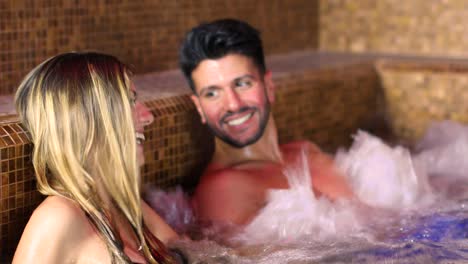young and happy couple inside a hot tube