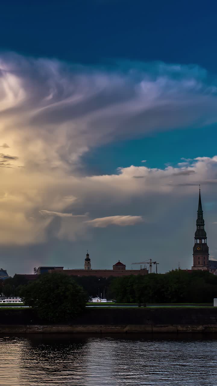 Vertical View St. Peter's Church Famous Spire With Daugava River In Riga, Latvia. Time lapse