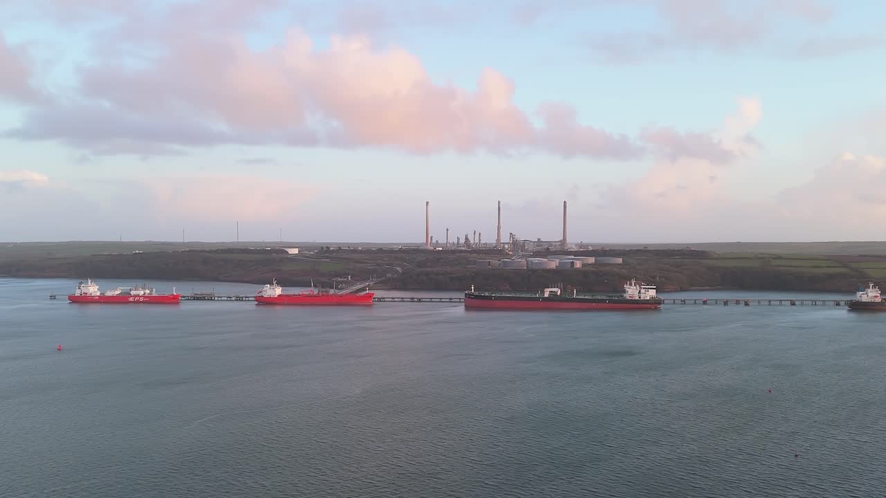 Refining oil tankers docked at Valero Pembroke Refinery with an industrial backdrop