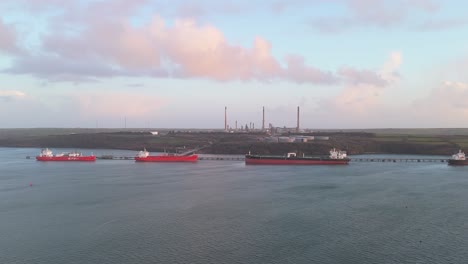 refining oil tankers docked at valero pembroke refinery with an industrial backdrop