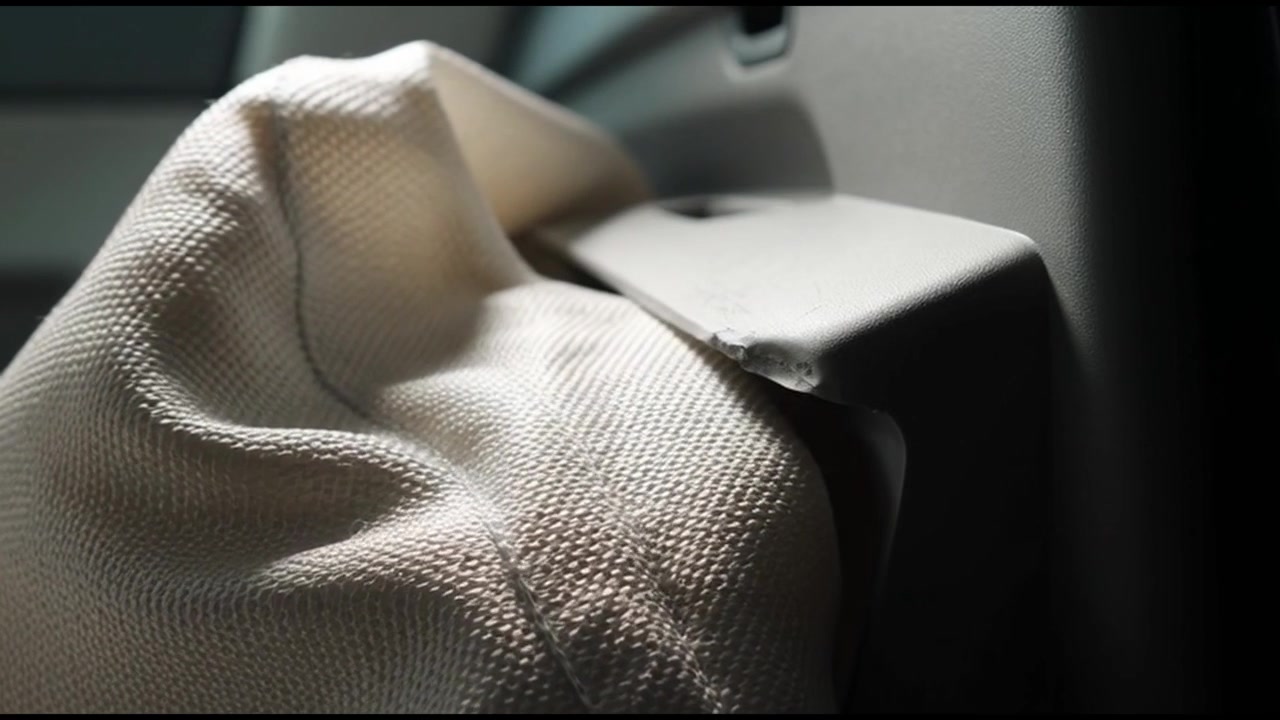 Close-up of a White Fabric Bag Resting on a Car Interior Panel