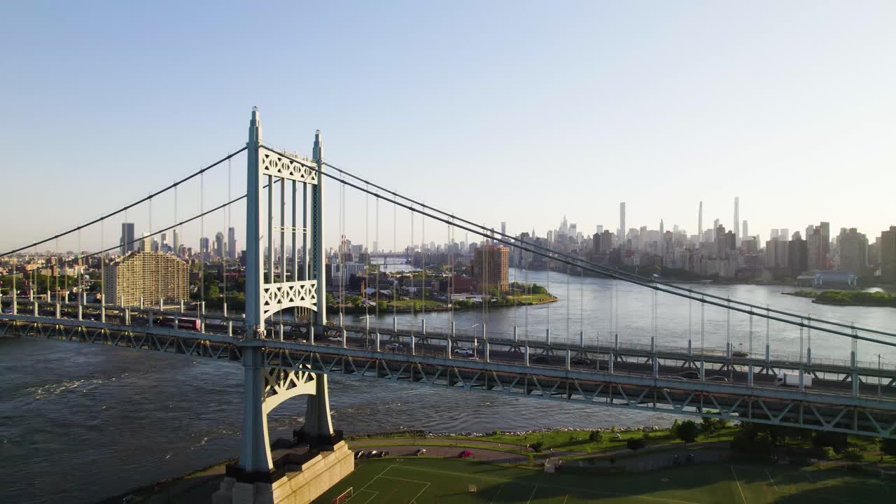 Smooth reverse drone clip of New York City with the Triboro Bridge in foreground