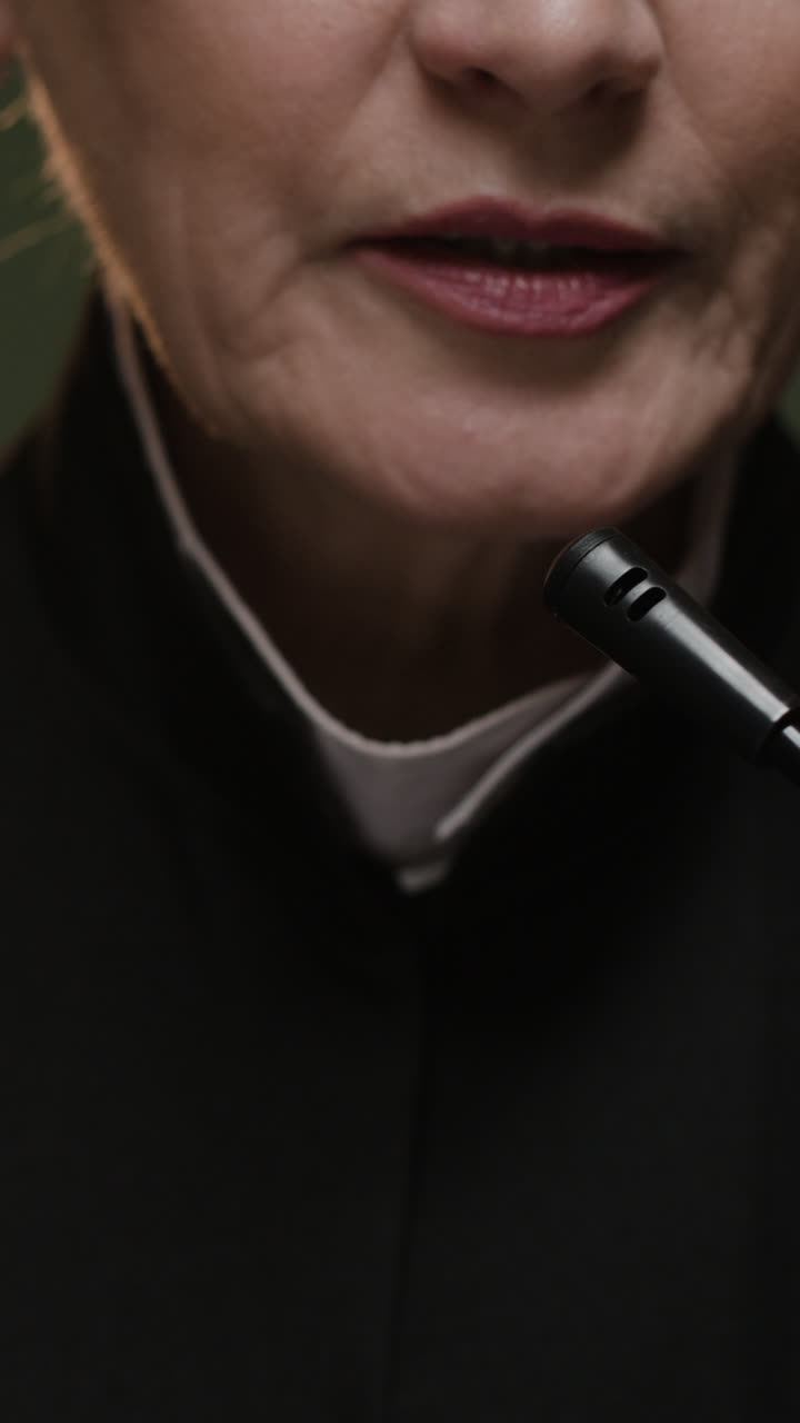 Woman Speaking into Microphone
