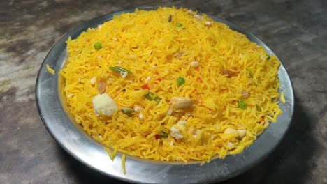 profile view of basanti pulao with nuts and raisins.