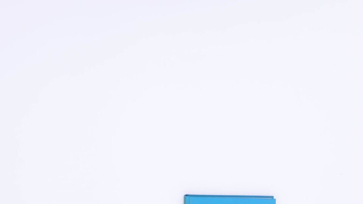 Blue book appear open and close on white background. Stop motion