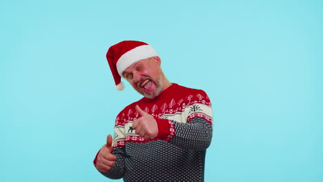 Funny-man-wears-red-New-Year-sweater-with-deers-raises-thumbs-up-agrees-with-something-good,-like