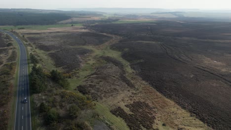 Flying-Over-The-Asphalt-Road-In-Goathland-Near-North-York-Moors-National-Park-In-North-Yorkshire,-England