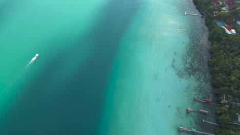 Aerial-view-of-Bacalar-Lagoon-coastline-with-hotel-and-resorts-along-the-shoreline,-Quintana-Roo,-Mexico