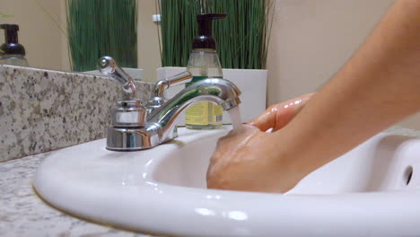 man washing his hands as recommended by the cdc in order to avoid contracting the coronavirus or covid-19 disease