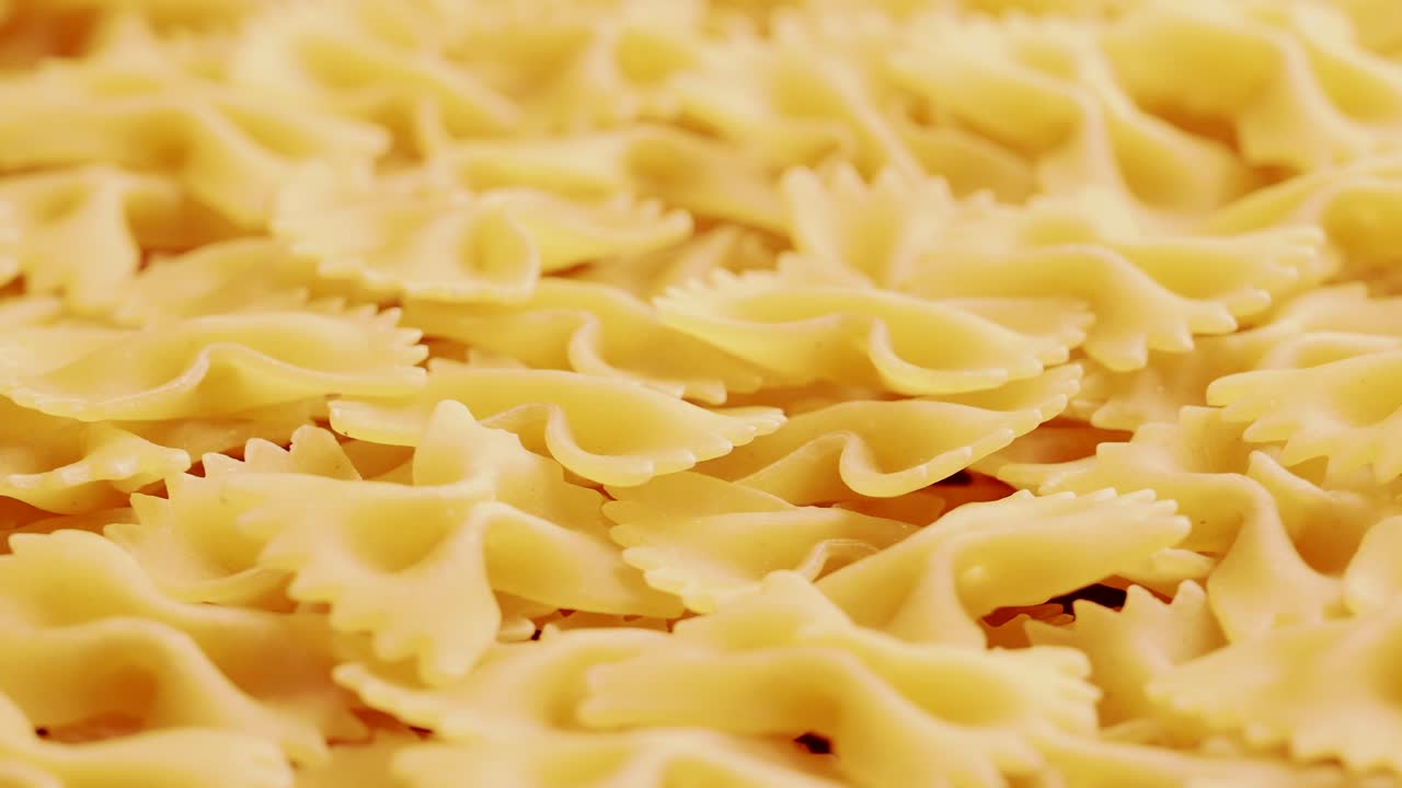 Pile of raw italian farfalle pasta in motion