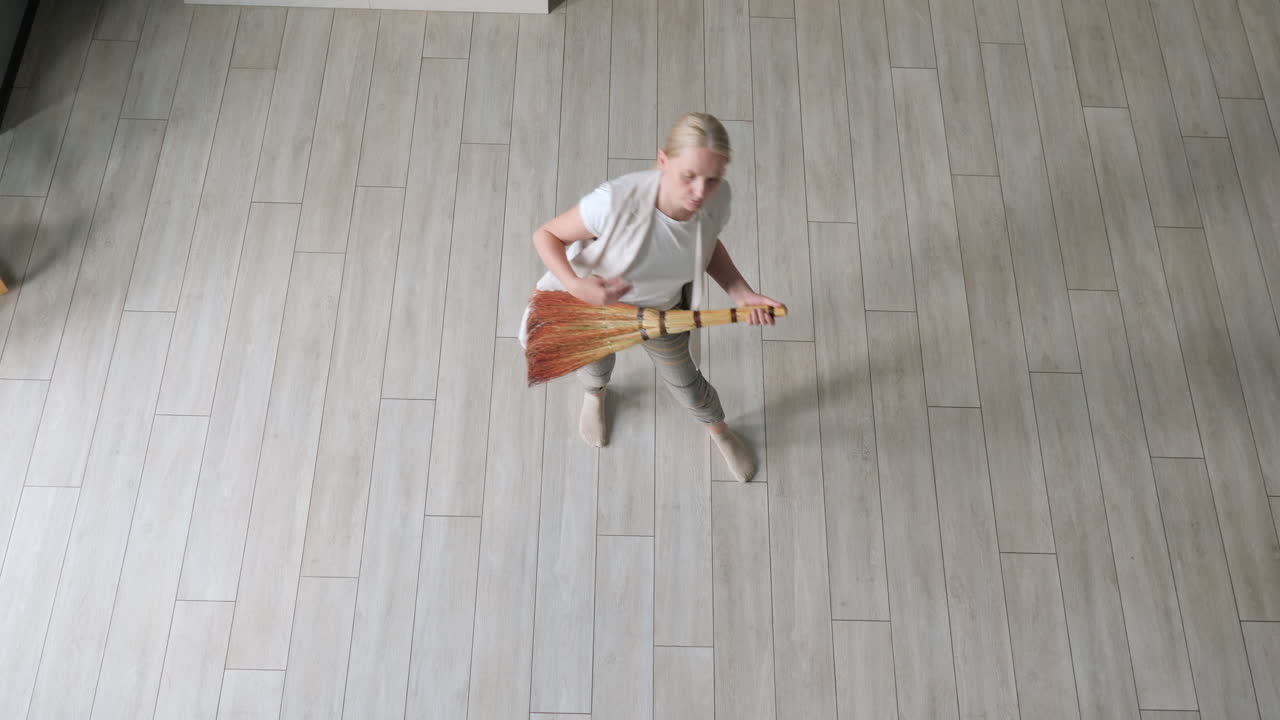 Woman Sweeping Floor