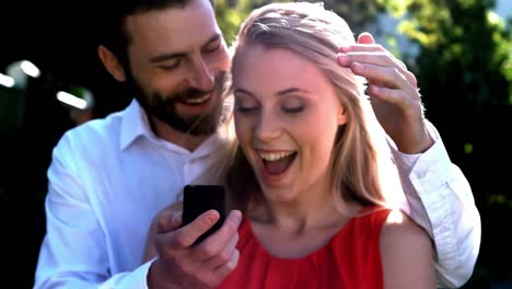 Smiling-man-offering-engagement-ring-while-proposing-to-woman