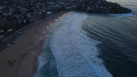 High-Evening-Drone-shot-along-Bondi-beach-at-dusk