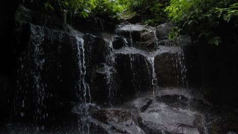 Tranquil-water-cascading-over-the-rocks-of-Kanto-Lampo-Waterfall-in-Bali,-Indonesia