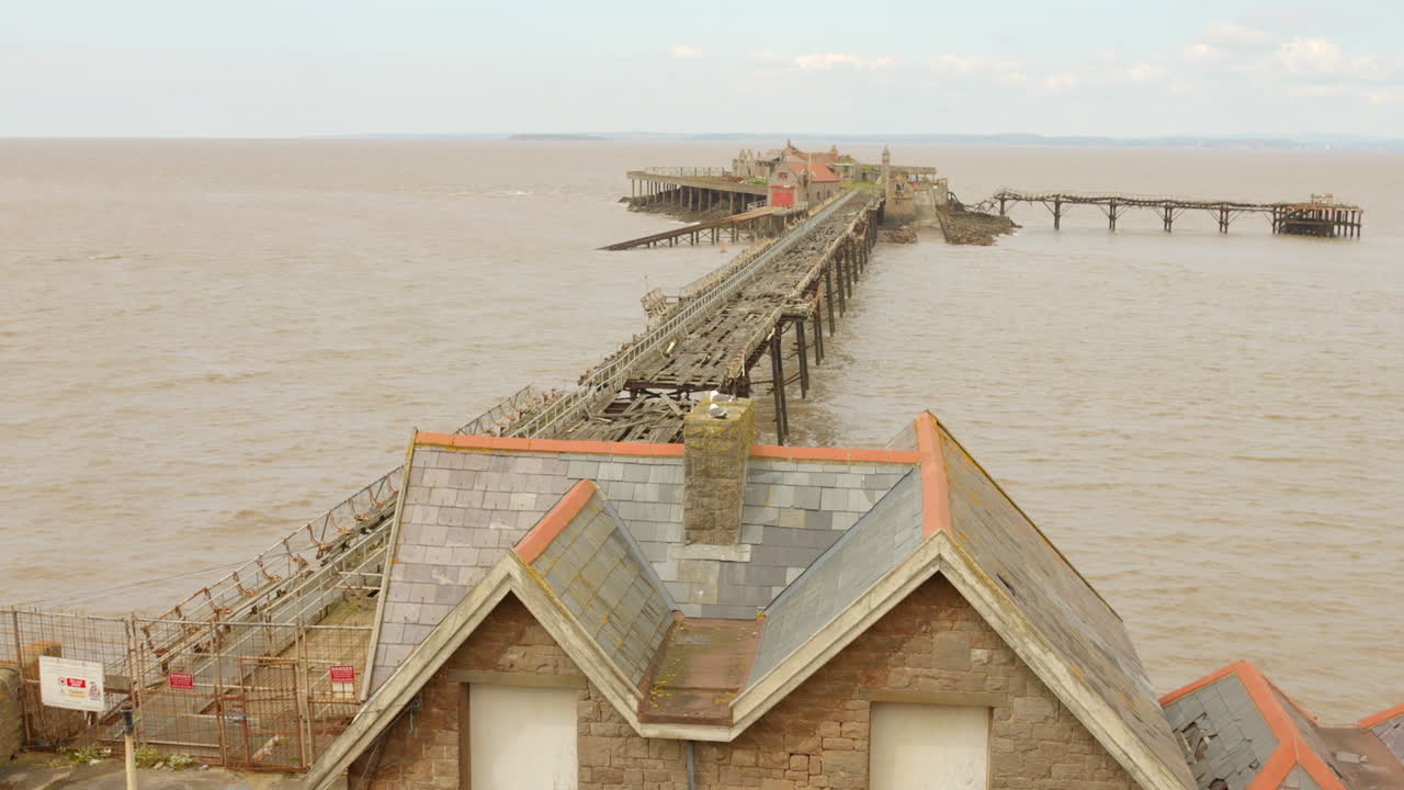 Abandoned Birnbeck Pier In Prince Consort Gardens, Weston-super-Mare, England. Aerial Drone Shot