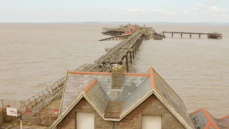 abandoned birnbeck pier in prince consort gardens, weston-super-mare, england. aerial drone shot