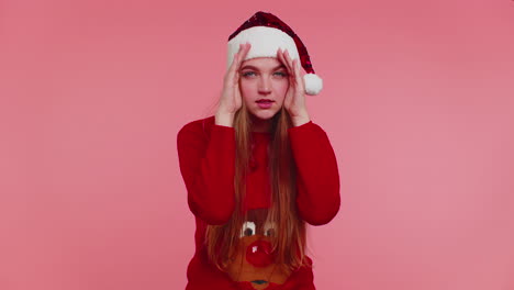 Woman-in-sweater-Santa-Christmas-hat-fooling-around-having-closing-eyes-with-hand-and-spying-through