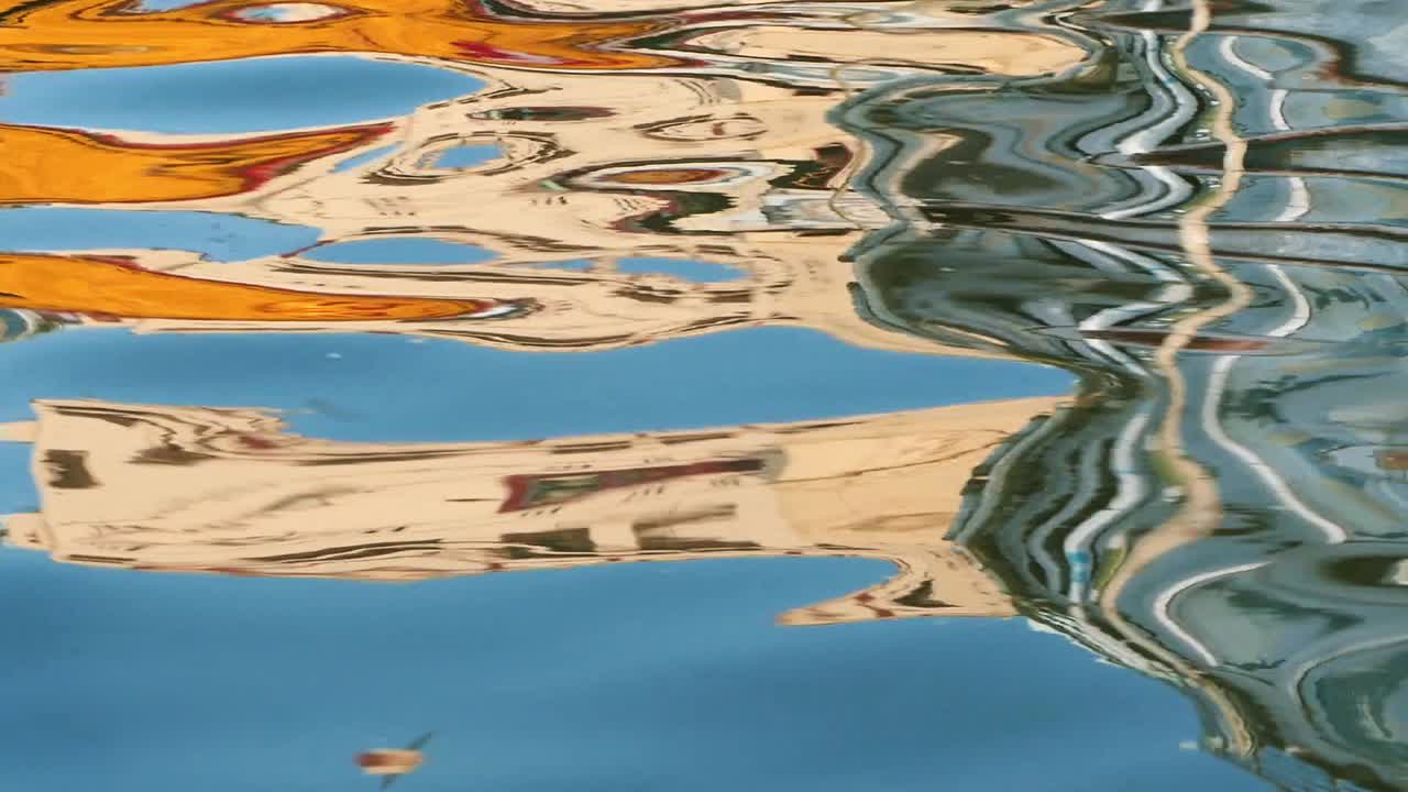 Bright reflection on water waves on the river of Varanasi, India - Close up