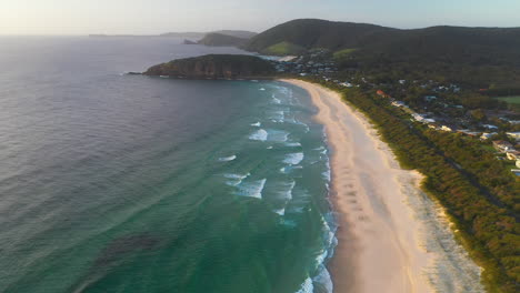 Aerial-view-of-Boomerang-Beach-at-sunset,-New-South-Wales-coastline,-Australia