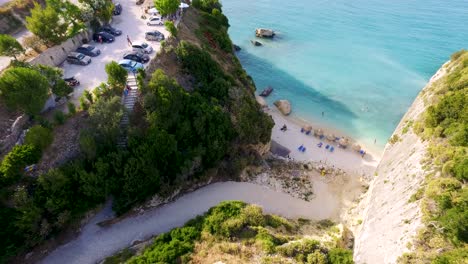 Xigia-beach-in-zakynthos,-greece-with-turquoise-waters-and-sunbathers,-aerial-view