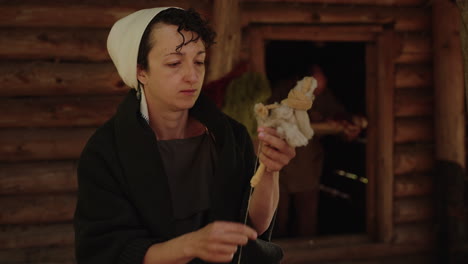 woman spinning wool in a historic setting