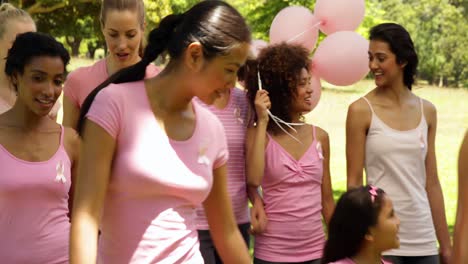 women going on a walk for breast cancer awareness in the park