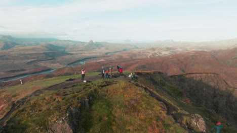 Flyover-above-group-of-hikers-on-summit-with