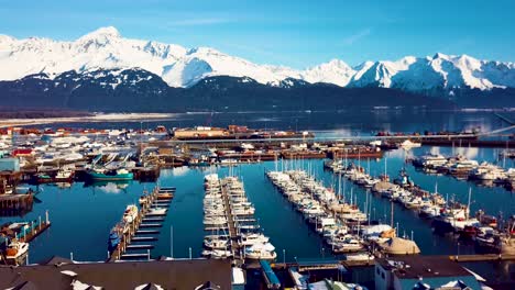 4K-Drone-Video-of-Seward-Boat-Harbor-and-Surrounding-Snow-Covered-Mountains-on-Snowy-Winter-Day-in-Alaska