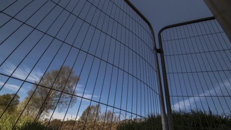 lapso de tiempo de las nubes que pasan a través de una valla de construcción