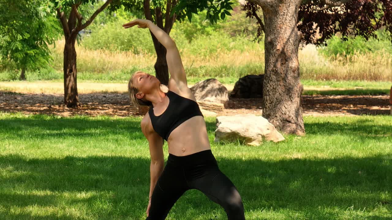 Peaceful calm and graceful a woman exercises with mindful poses in a public park