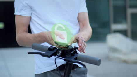 electronic scooter is unlocked and light is turned on with the help of young man's smartphone app