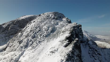 drone lifting panning shot of the bla bheinn at isle of skye in scotland in winter time