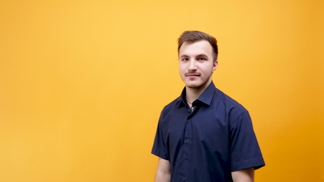 Portrait of a Man in Blue Shirt on Yellow Background