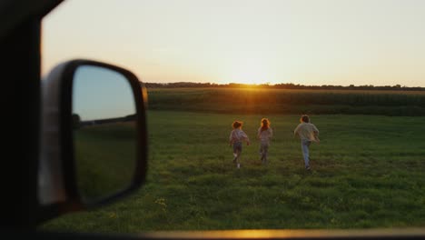 friends running in a field at sunset