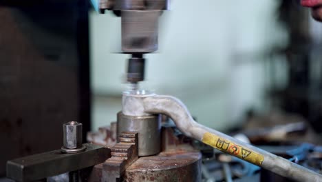 worker at production plant. man in production plant drilling at machine on the factory