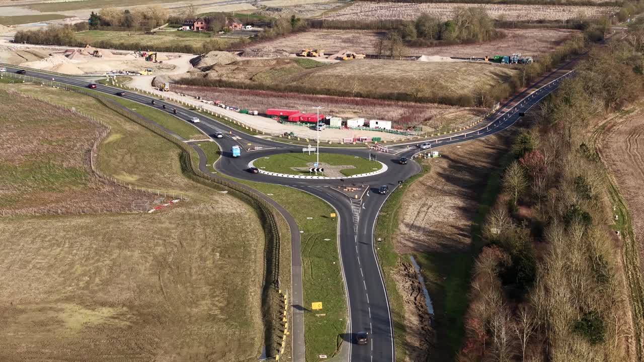 Aerial view of busy UK roundabout managing traffic in rural development zone, Waddesdon A41 road