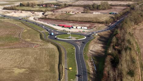 aerial view of busy uk roundabout managing traffic in rural development zone, waddesdon a41 road