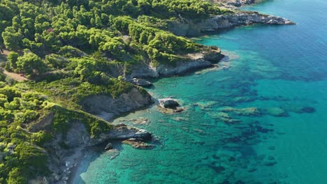 a vibrant coastal landscape with turquoise waters and lush green forests , aerial view