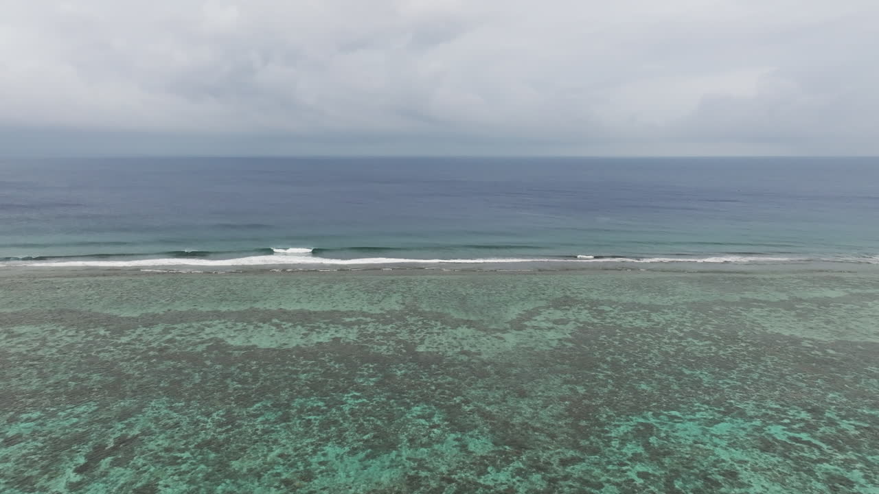 Drone view of turquoise water of South Pacific ocean of Cook Islands with endless horizon.