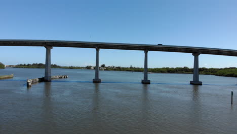 a panning aerial shot of one of the many causeways spanning the indian river lagoon