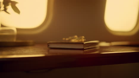 woman touching pad screen in luxury airplane. hands swipe tablet charts closeup