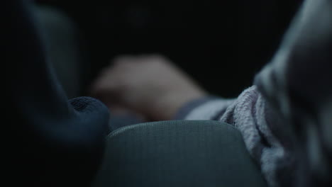 Hands in a car at night