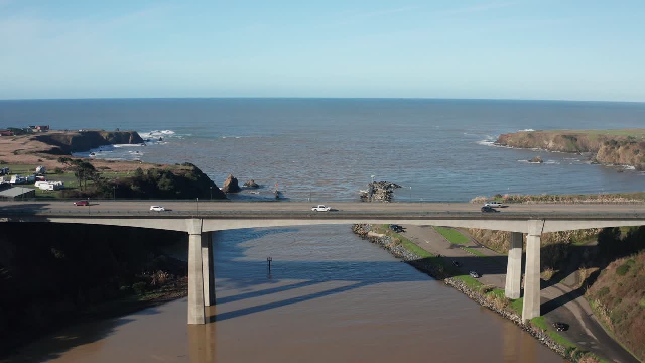 Wide aerial pullback shot of Noyo Bay and Noyo Bridge in Fort Bragg, California. 4K